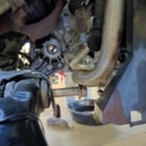 Preview thumbnail for Can't remove lower control arm bolt because a/c compressor line blocking it. Can I jack the engine block?