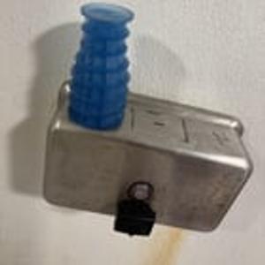 Preview thumbnail for Blue silicone object with waffle texture in a public bathroom